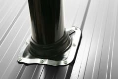 Eight screws holding ArcticVent to black steel roof