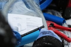 Gloved hand cutting heating cable with exacto knife