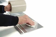 Hand putting plastic seal on EDGE-CUTTER