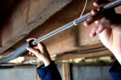 Hands holding pipe with Paladin and Insulation installed on pipe