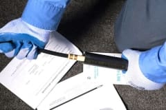 Gloved Hand Dispensing Retro-Line into Pipe