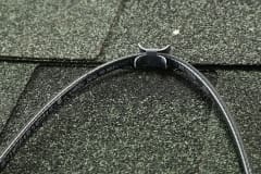 Paladin for Roof clipped onto green shingled roof