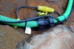 Inter-connecting, self-regulating heat trace system on pipe outdoors in dirt