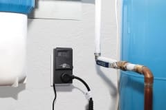 HLA-120 thermostat plugged into outlet on wall inside